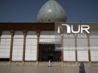 Veiled Iranian women walk along an area in a holy shrine in Shiraz, Iran, on October 8, 2024. Western countries express concern about a pote...