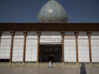 Veiled Iranian women walk along an area in a holy shrine in Shiraz, Iran, on October 8, 2024. Western countries express concern about a pote...