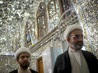 Two Iranian clerics stand next to a tomb in a holy shrine in Shiraz, Iran, on October 8, 2024. While Western countries express concern about...