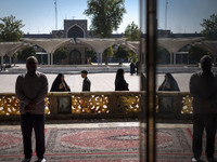 Muslim people pray while standing in a holy shrine in Shiraz, Iran, on October 8, 2024. Western countries express concern about a potential...