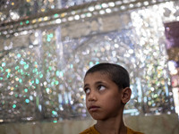 A young Iranian boy stands next to a tomb (not pictured) in a holy shrine in Shiraz, Iran, on October 8, 2024. Western countries express con...