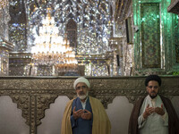 Two Iranian clerics pray next to a tomb in a holy shrine in Shiraz, Iran, on October 8, 2024. Western countries express concern about a pote...