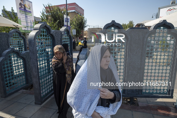 Veiled Iranian women arrive at a holy shrine in Shiraz, Iran, on October 8, 2024. While Western countries express concern about a potential...