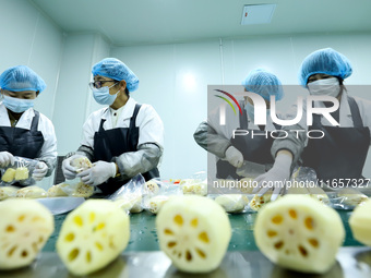 Workers process fresh and purified vegetables for major merchants at a purification processing and distribution line in Zhangye, China, on O...