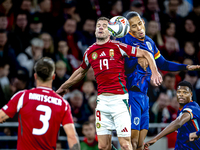 Hungary forward Barnabas Varga and Netherlands defender Virgil van Dijk play during the match between Hungary and the Netherlands at the Pus...