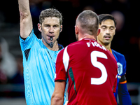 Hungary defender Attila Fiola receives a yellow card from Referee Lukas Fahndrich during the match between Hungary and the Netherlands at th...