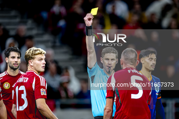 Hungary defender Attila Fiola receives a yellow card from Referee Lukas Fahndrich during the match between Hungary and the Netherlands at th...