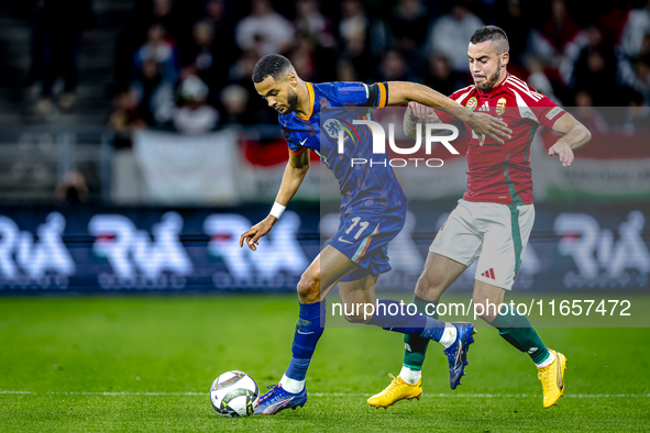 Netherlands forward Cody Gakpo and Hungary defender Endre Botka play during the match between Hungary and the Netherlands at the Puskas Aren...