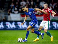 Netherlands forward Cody Gakpo and Hungary defender Endre Botka play during the match between Hungary and the Netherlands at the Puskas Aren...