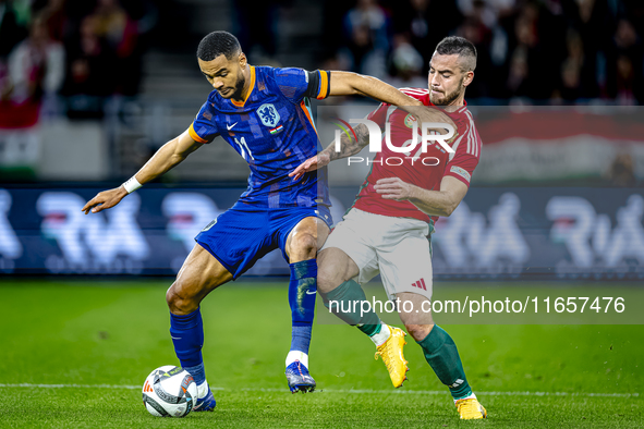 Netherlands forward Cody Gakpo and Hungary defender Endre Botka play during the match between Hungary and the Netherlands at the Puskas Aren...