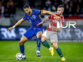 Netherlands forward Cody Gakpo and Hungary defender Endre Botka play during the match between Hungary and the Netherlands at the Puskas Aren...