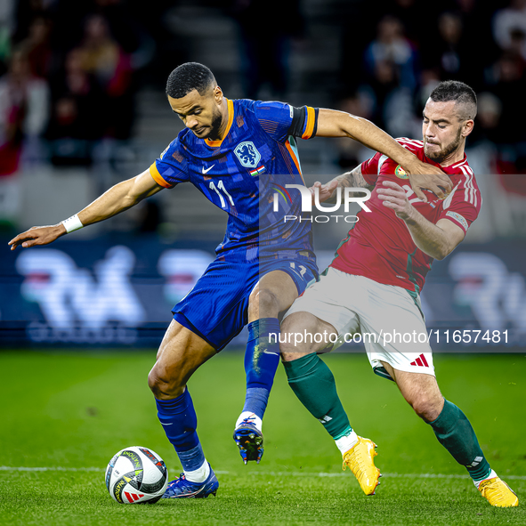 Netherlands forward Cody Gakpo and Hungary defender Endre Botka play during the match between Hungary and the Netherlands at the Puskas Aren...