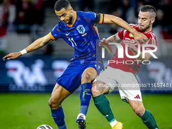 Netherlands forward Cody Gakpo and Hungary defender Endre Botka play during the match between Hungary and the Netherlands at the Puskas Aren...