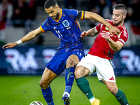 Netherlands forward Cody Gakpo and Hungary defender Endre Botka play during the match between Hungary and the Netherlands at the Puskas Aren...