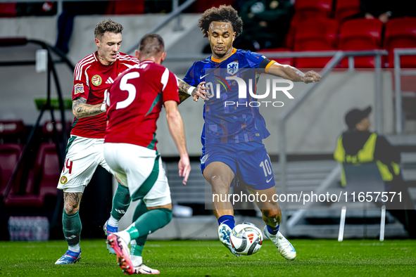 Netherlands forward Joshua Zirkzee and Hungary defender Bendeguz Bolla play during the match between Hungary and the Netherlands at the Pusk...