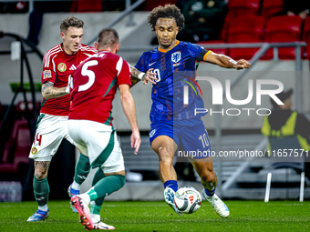 Netherlands forward Joshua Zirkzee and Hungary defender Bendeguz Bolla play during the match between Hungary and the Netherlands at the Pusk...