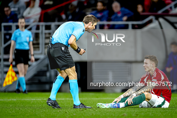 Referee Lukas Fahndrich and Hungary defender Bendeguz Bolla participate in the match between Hungary and the Netherlands at the Puskas Arena...