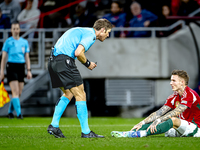 Referee Lukas Fahndrich and Hungary defender Bendeguz Bolla participate in the match between Hungary and the Netherlands at the Puskas Arena...