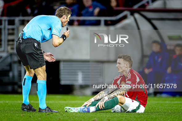 Referee Lukas Fahndrich and Hungary defender Bendeguz Bolla participate in the match between Hungary and the Netherlands at the Puskas Arena...