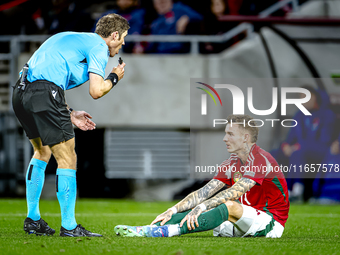 Referee Lukas Fahndrich and Hungary defender Bendeguz Bolla participate in the match between Hungary and the Netherlands at the Puskas Arena...