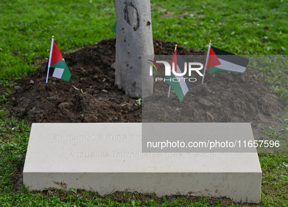 BAYEUX, FRANCE - OCTOBER 11: 
An olive tree stands beside the inscription, 'In memory of an unprecedented tragedy, To all journalists killed...