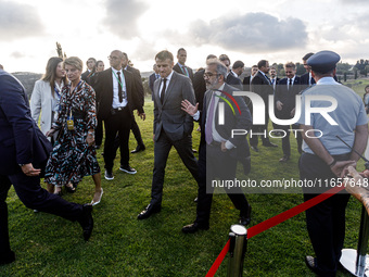 President of France Emmanuel Macron and Portugal Minister of Foreign Affairs Paulo Rangel leave the family photo area in Paphos, Cyprus, on...