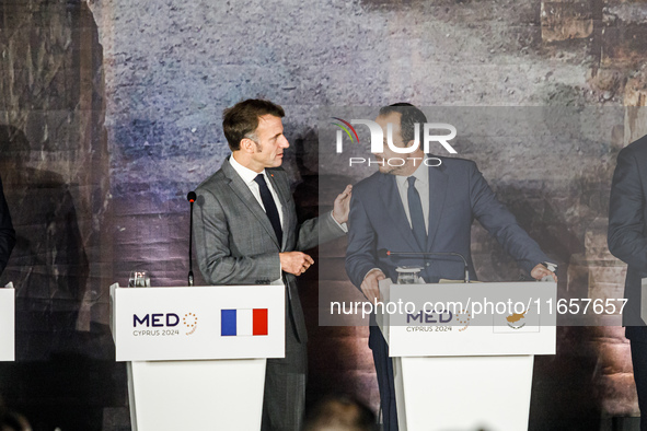 President of France Emmanuel Macron and President of Cyprus Nikos Christodoulides talk before the press conference in Paphos, Cyprus, on Oct...