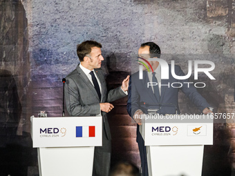 President of France Emmanuel Macron and President of Cyprus Nikos Christodoulides talk before the press conference in Paphos, Cyprus, on Oct...