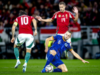 Hungary midfielder Dominik Szoboszlai, Netherlands defender Stefan de Vrij, and Hungary forward Barnabas Varga participate in the match betw...