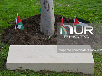 BAYEUX, FRANCE - OCTOBER 11: 
An olive tree stands beside the inscription, 'In memory of an unprecedented tragedy, To all journalists killed...