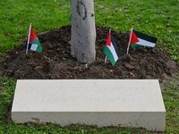 BAYEUX, FRANCE - OCTOBER 11: 
An olive tree stands beside the inscription, 'In memory of an unprecedented tragedy, To all journalists killed...