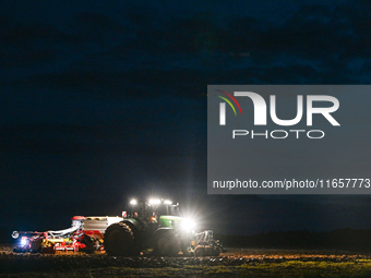 FONTENAY-LE-PESNEL, FRANCE - OCTOBER 11: 
A tractor John Deere 6250R pulls the AEROSEM POTTINGER pneumatic seed drill through a field near F...