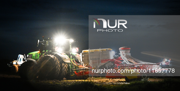 FONTENAY-LE-PESNEL, FRANCE - OCTOBER 11: 
A tractor John Deere 6250R pulls the AEROSEM POTTINGER pneumatic seed drill through a field near F...