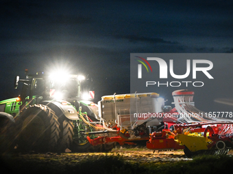 FONTENAY-LE-PESNEL, FRANCE - OCTOBER 11: 
A tractor John Deere 6250R pulls the AEROSEM POTTINGER pneumatic seed drill through a field near F...