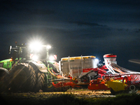 FONTENAY-LE-PESNEL, FRANCE - OCTOBER 11: 
A tractor John Deere 6250R pulls the AEROSEM POTTINGER pneumatic seed drill through a field near F...