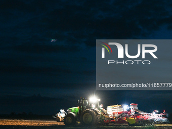 FONTENAY-LE-PESNEL, FRANCE - OCTOBER 11: 
A tractor John Deere 6250R pulls the AEROSEM POTTINGER pneumatic seed drill through a field near F...