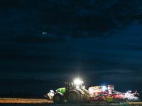 FONTENAY-LE-PESNEL, FRANCE - OCTOBER 11: 
A tractor John Deere 6250R pulls the AEROSEM POTTINGER pneumatic seed drill through a field near F...