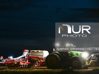 FONTENAY-LE-PESNEL, FRANCE - OCTOBER 11: 
A tractor John Deere 6250R pulls the AEROSEM POTTINGER pneumatic seed drill through a field near F...