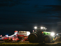 FONTENAY-LE-PESNEL, FRANCE - OCTOBER 11: 
A tractor John Deere 6250R pulls the AEROSEM POTTINGER pneumatic seed drill through a field near F...