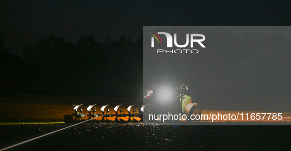 FONTENAY-LE-PESNEL, FRANCE - OCTOBER 11: 
A tractor plows the field with a heavy plough on an October night near Fontenay-le-Pesnel, Calvado...