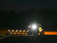 FONTENAY-LE-PESNEL, FRANCE - OCTOBER 11: 
A tractor plows the field with a heavy plough on an October night near Fontenay-le-Pesnel, Calvado...