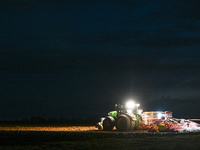 FONTENAY-LE-PESNEL, FRANCE - OCTOBER 11: 
A tractor John Deere 6250R pulls the AEROSEM POTTINGER pneumatic seed drill through a field near F...