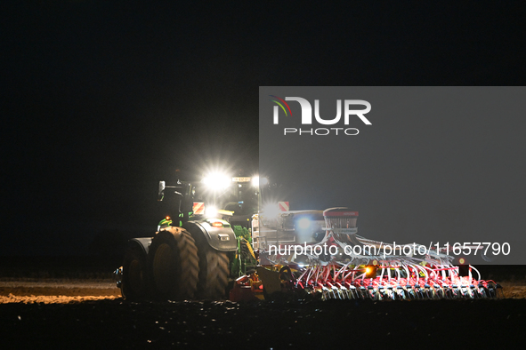 FONTENAY-LE-PESNEL, FRANCE - OCTOBER 11: 
A tractor John Deere 6250R pulls the AEROSEM POTTINGER pneumatic seed drill through a field near F...