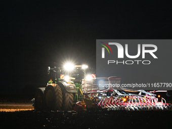 FONTENAY-LE-PESNEL, FRANCE - OCTOBER 11: 
A tractor John Deere 6250R pulls the AEROSEM POTTINGER pneumatic seed drill through a field near F...