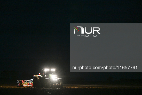 FONTENAY-LE-PESNEL, FRANCE - OCTOBER 11: 
A tractor John Deere 6250R pulls the AEROSEM POTTINGER pneumatic seed drill through a field near F...