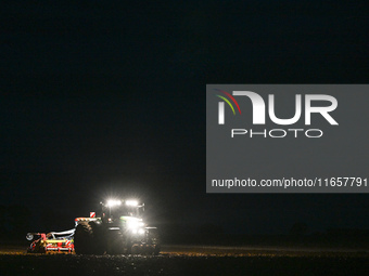 FONTENAY-LE-PESNEL, FRANCE - OCTOBER 11: 
A tractor John Deere 6250R pulls the AEROSEM POTTINGER pneumatic seed drill through a field near F...