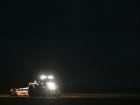 FONTENAY-LE-PESNEL, FRANCE - OCTOBER 11: 
A tractor John Deere 6250R pulls the AEROSEM POTTINGER pneumatic seed drill through a field near F...