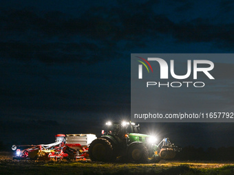 FONTENAY-LE-PESNEL, FRANCE - OCTOBER 11: 
A tractor John Deere 6250R pulls the AEROSEM POTTINGER pneumatic seed drill through a field near F...