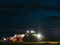 FONTENAY-LE-PESNEL, FRANCE - OCTOBER 11: 
A tractor John Deere 6250R pulls the AEROSEM POTTINGER pneumatic seed drill through a field near F...