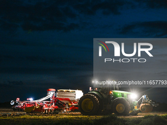 FONTENAY-LE-PESNEL, FRANCE - OCTOBER 11: 
A tractor John Deere 6250R pulls the AEROSEM POTTINGER pneumatic seed drill through a field near F...